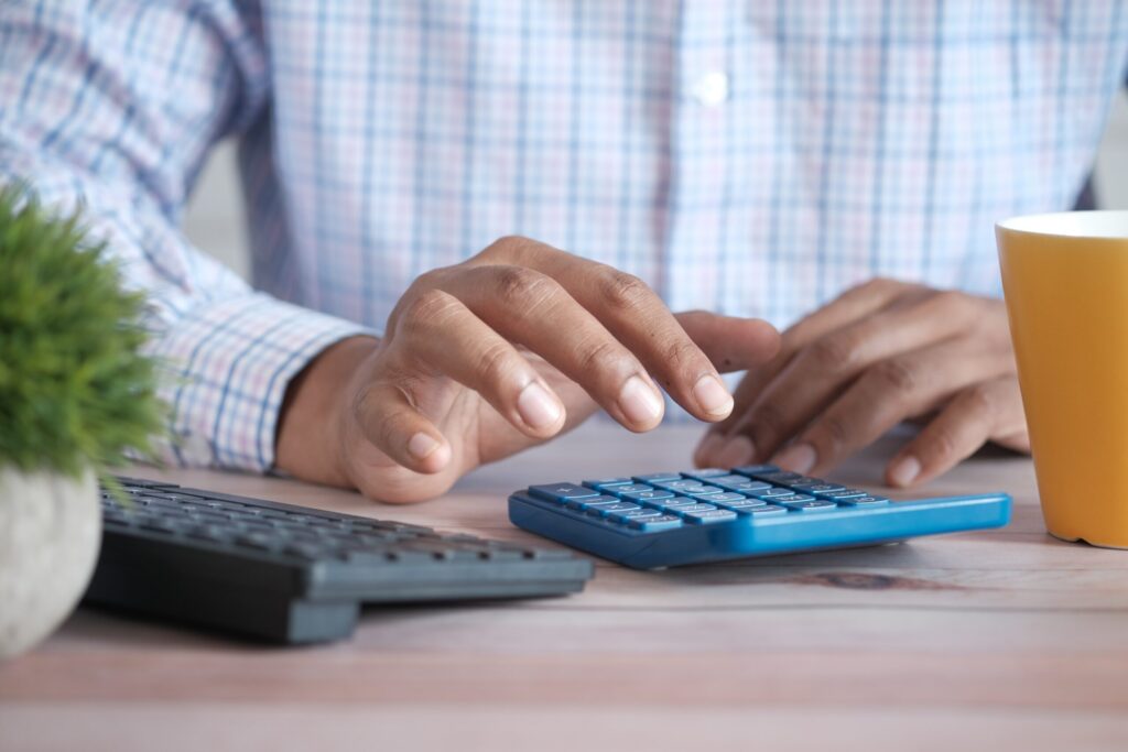 Executor working out inheritance tax on a calculator